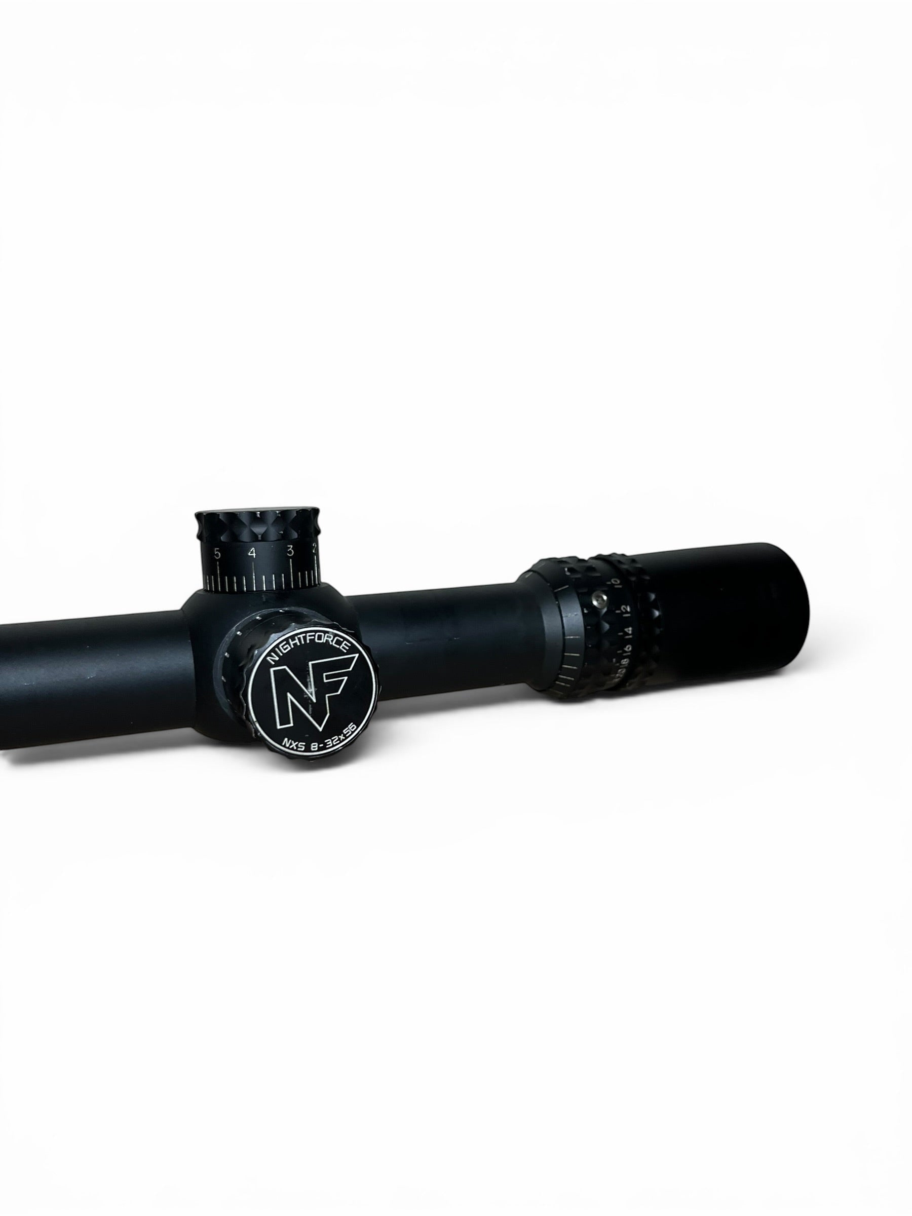 Optics Outlet UK used Nightforce NXS 8-32x56 rifle scope with black finish and illuminated NP-2DD reticle.
