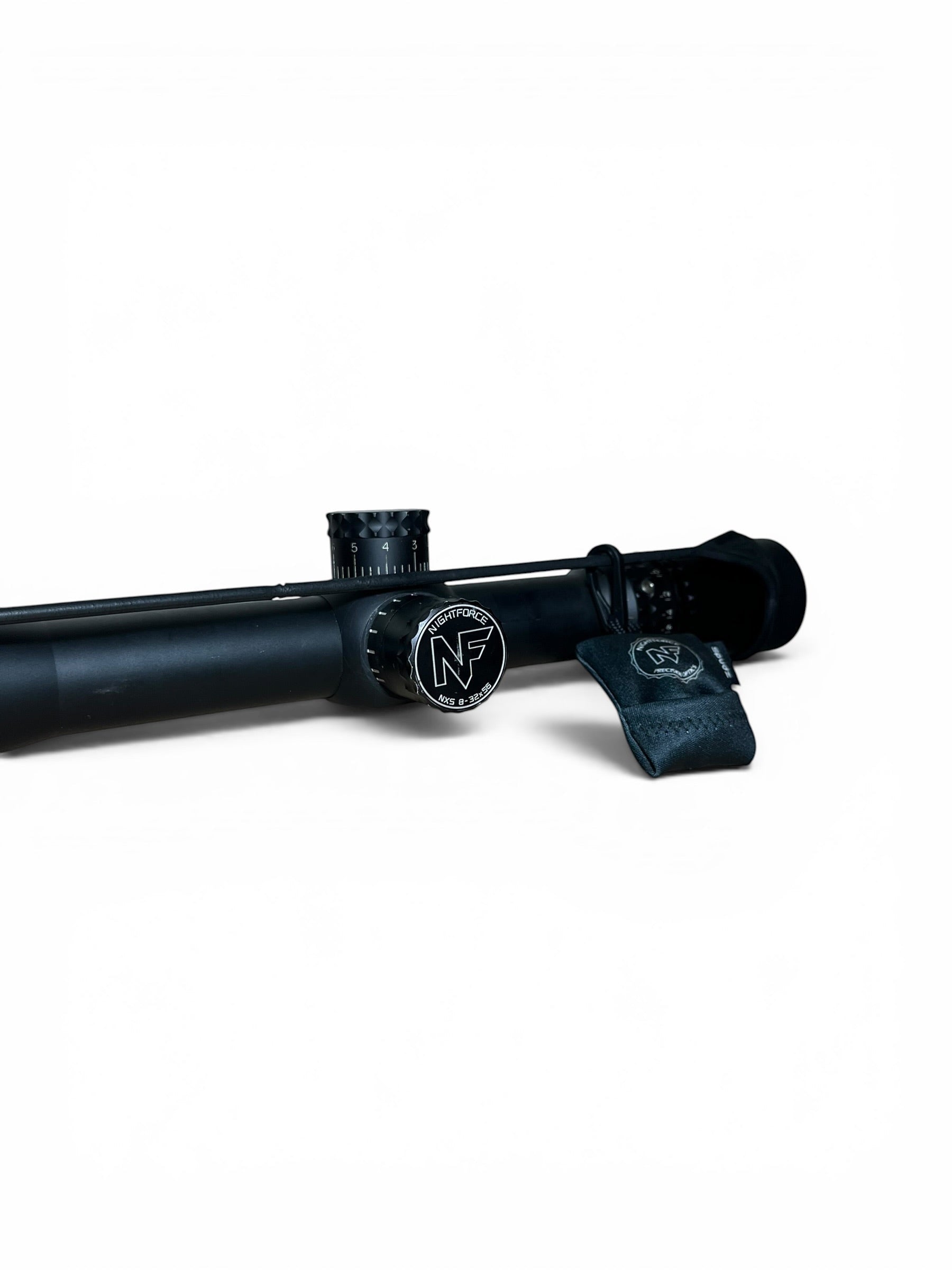 Optics Outlet UK used Nightforce NXS 8-32x56 rifle scope in black with NP-2DD illuminated reticle and lens cover.